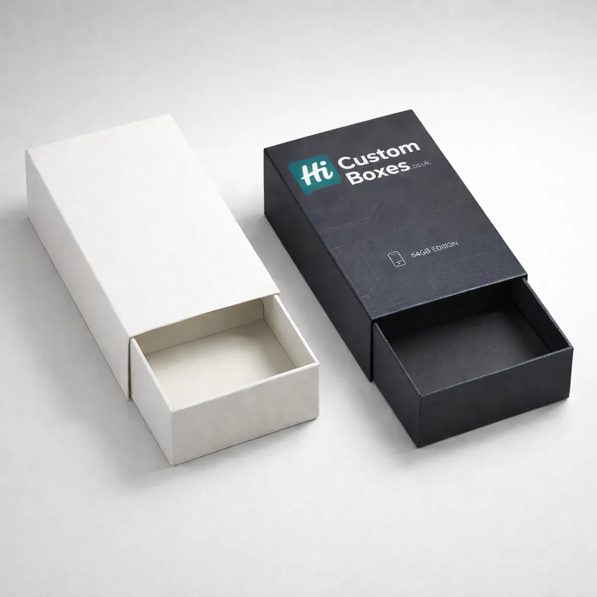 Two sliding drawer-style matchbox packs, showing a minimalist white sleeve and a black branded sleeve partially open. class=